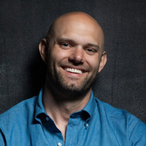 James Clear smiling in a photoshoot to promote Atomic Habits